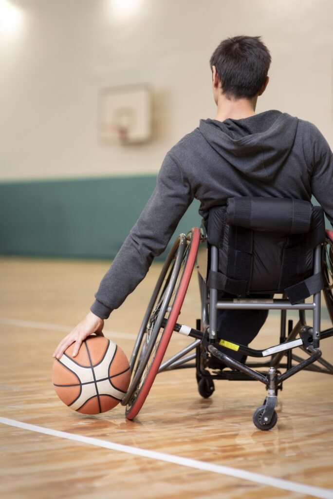 close up disabled man holding basketball