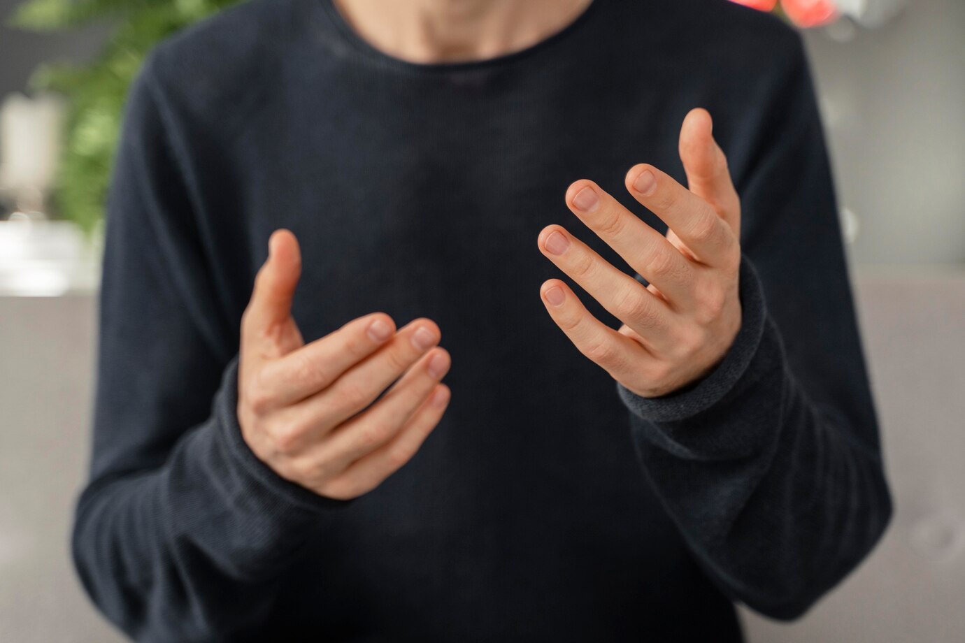 Trigger Finger 1 Adult looking at both hands while noticing finger movement symptoms