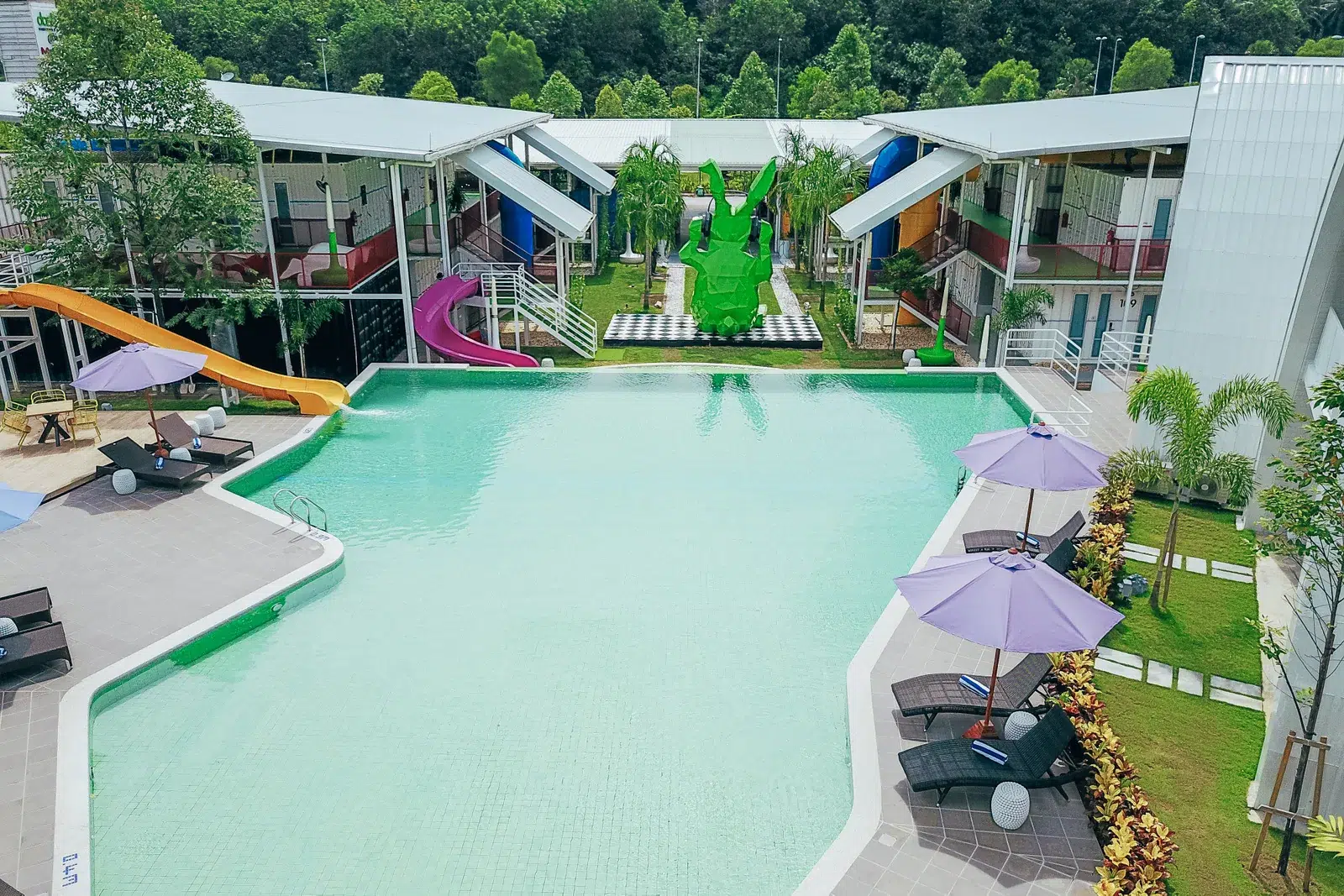 Rehabilitation at dash Box Hotel Cyberjaya 7 Outdoor hotel pool with loungers and colourful slides at dash Box Hotel Cyberjaya