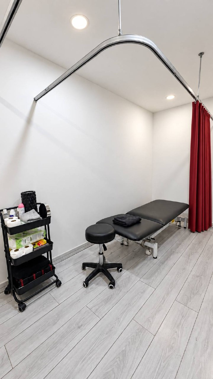 Rehabilitation at dash Box Hotel Cyberjaya 6 Physiomobile treatment room with a treatment bed and privacy curtain at Dash Box Hotel Cyberjaya